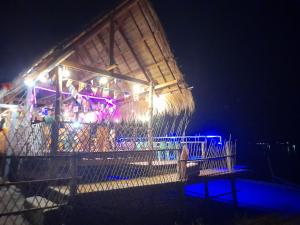 a building with lights on it at night at Champasak Backpacker in Ban Mouang