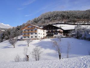 ロデンゴにあるPension Steigerhofの雪田の大きな建物