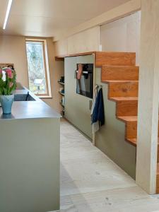 a kitchen with a counter and a stove top oven at Architectural Tiny House With Sauna Near Beach in Asnæs