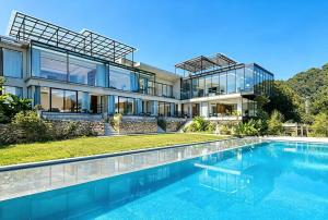 an exterior view of a house with a swimming pool at Purespace --2nights 1pick-up&trip tickets&5min to park gate in Zhangjiajie