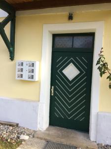 a green door on the side of a house at Seevilla Annenheim in Annenheim