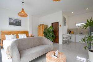 a living room with a couch and a kitchen at Polly Canggu 1BR Private Pool Villa By Bali Bliss Properties in Buduk