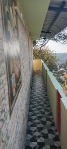 a hallway of a building with paintings on the wall at UP enterprices in Yercaud
