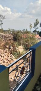 a view of a field from a balcony with a fence at UP enterprices in Yercaud +7 photos