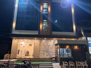 a building with motorcycles parked in front of a store at Fairview Anayaa in Khātu
