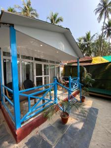 a small house with a blue and white roof at Mystic Nest in Canacona