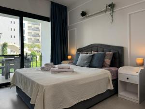 a bedroom with a large bed with towels on it at Caesar Blue Collection Nothern Cyprus Studios & Spa Resort in Kaimakli +88 photos