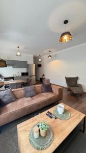 a living room with a couch and a table at EVIS LTD apartments 3 in Rēzekne