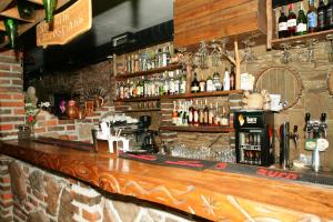 a bar with bottles of alcohol on a brick wall at Готель Млин in Nikolayev
