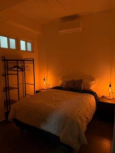 a bedroom with a bed and two lamps and a shelf at Freya studio IV Romantic Zone in Puerto Vallarta