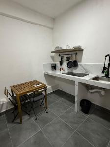 a kitchen with a counter and a table and a sink at Freya studio IV Romantic Zone in Puerto Vallarta