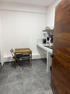 a table and chairs in a kitchen with a counter at Freya studio IV Romantic Zone in Puerto Vallarta