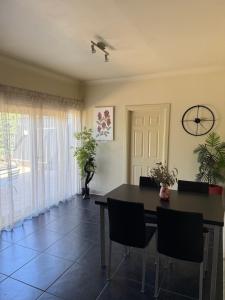 a dining room with a table and chairs at Lotte's Cottage in Broken Hill