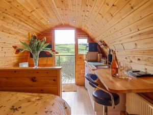 a tiny house with a kitchen and a large window at The Rhiw in Newtown