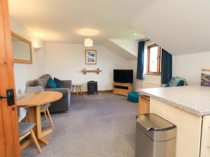 a kitchen and living room with a table and a counter at High Dow Crag in Coniston