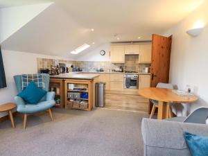 an open kitchen and dining room with a table and chairs at High Dow Crag in Coniston