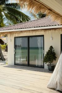 a house with a sliding glass door with a view of the ocean at Sabay Koh Rong in Koh Rong Island