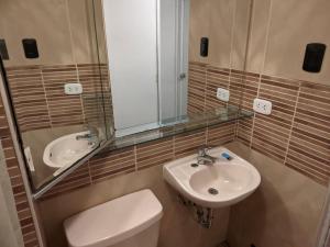 a bathroom with a sink and a toilet and a mirror at Blue Coast Lima private rooms Peru in Lima +42 photos