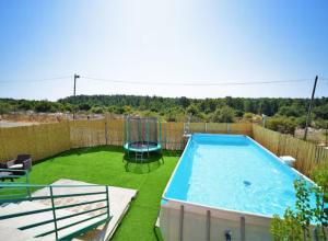 a backyard with a pool and a swing at נוף הרים בר יוחאי - בית נופש מדהים עם בריכה וג'קוזי in Bar Yohai