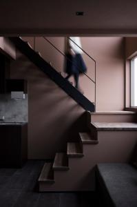 a person walking down a staircase in a building at monel in Nakafurano