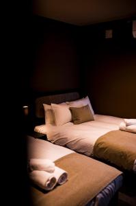 two beds sitting next to each other in a room at monel in Nakafurano