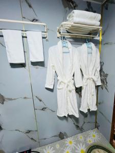 a rack of white clothes hanging on a wall at Mandakh Naran Guest House in Dzuunmod +34 photos
