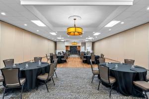 a conference room with tables and chairs and a podium at Clarion Inn North Haven - New Haven North in North Haven +53 photos