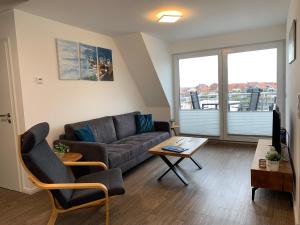a living room with a couch and a table at Ferienwohnungen Wassergrundstück Malchow in Malchow