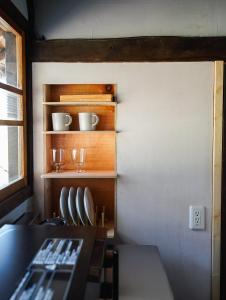a dining room with a table and chairs and a window at ノキシタ in Hokuto +1 photo