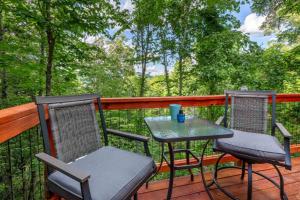 two chairs and a table on a deck at Holly Hideaway in Cullowhee