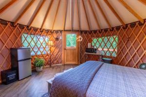 a bedroom with a bed in a yurt at Holly Hideaway in Cullowhee