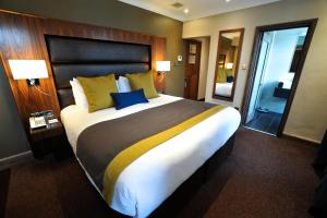 A bed or beds in a room at Frensham Pond Country House Hotel & Spa 