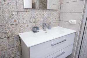 a bathroom with a white sink and a mirror at Ali apartments in Pizzo +5 photos