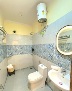 a bathroom with a toilet and a sink and a mirror at TT Homes Private Studio Suites Jaipur Pink City in Jaipur