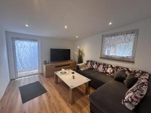 a living room with a couch and a table at Ferienwohnung Nestblick in Weilburg