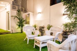 a group of white chairs and a table in a yard at Venue Colombo in Colombo +15 photos