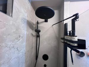 a shower in a bathroom with a shower head at MOREHOME Zentral Parkplatz Balkon nähe Therme in Bad Wörishofen