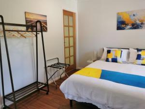 a bedroom with a bed and a loft bed with a ladder at Creekside Cottage - Private Studio with Mountain View in Coffs Harbour