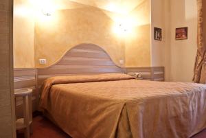 Postel nebo postele na pokoji v ubytování Hotel Nedy