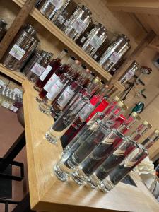 a bar with several wine glasses on a counter at Das Weinstöckl in Inzenhof