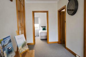 a hallway with a room with a bed and a clock at Hidden Gem - St Mary's in Saint Marys