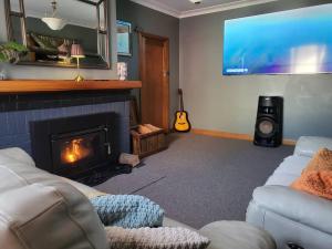 a living room with a fireplace and a tv at Hidden Gem - St Mary's in Saint Marys