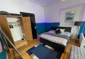 a small room with two beds and a cabinet at Urban Grand Suite in Berlin