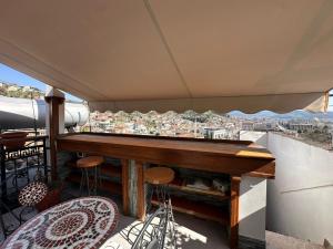 a balcony with a table and chairs and a view at Vila Darla in Berat