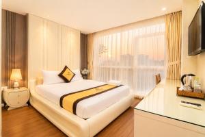 a bedroom with a large bed and a window at Golden Star Hotel in Ho Chi Minh City