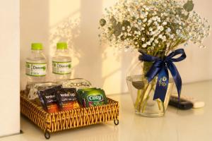 a basket of chips and a vase of flowers and drinks at Golden Star Hotel in Ho Chi Minh City +15 photos