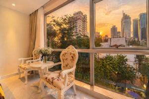 a room with a table and chairs and a window at Golden Star Hotel in Ho Chi Minh City