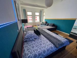 a bedroom with a large bed and a couch at Urban Grand Suite in Berlin