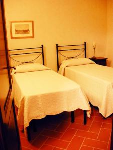 Postel nebo postele na pokoji v ubytování Relais Villa Sensano