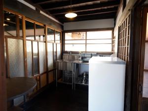a kitchen with a sink and a counter in a room at ノキシタ in Hokuto
